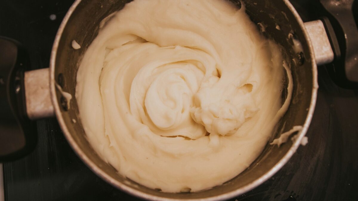 a pot of cream sitting on top of a stove