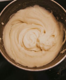 a pot of cream sitting on top of a stove