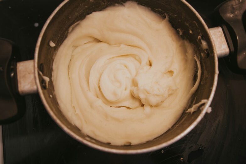 a pot of cream sitting on top of a stove