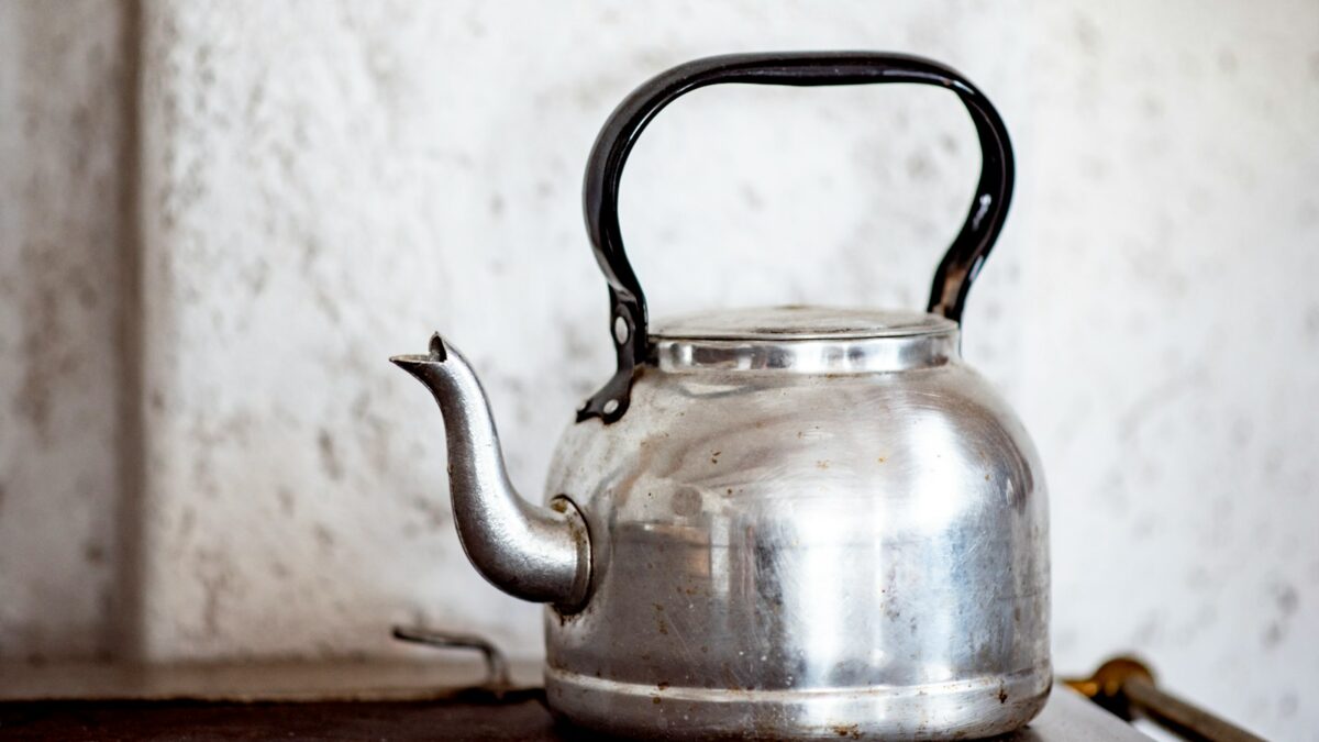 stainless steel kettle on brown wooden table