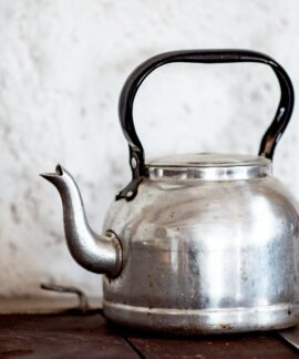 stainless steel kettle on brown wooden table