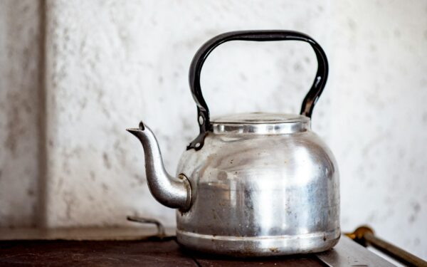 stainless steel kettle on brown wooden table