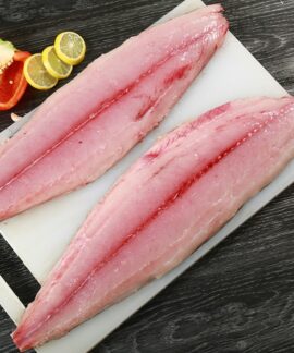 two raw fish fillets on a cutting board