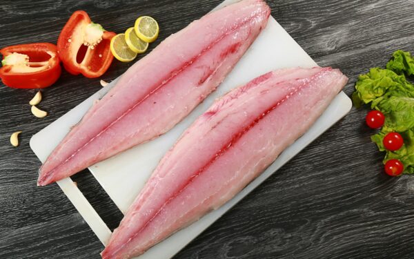 two raw fish fillets on a cutting board