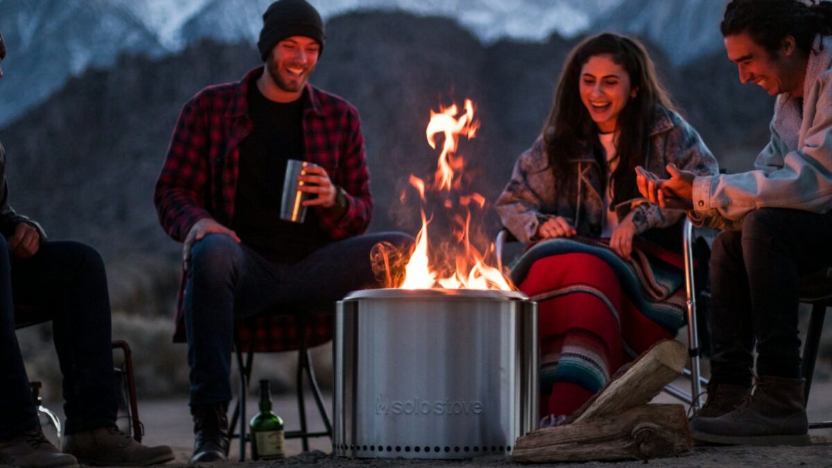 a group of people sitting around a fire pit