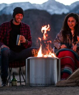 a group of people sitting around a fire pit