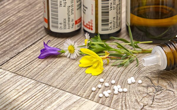 A bottle of medicine sitting on top of a wooden table