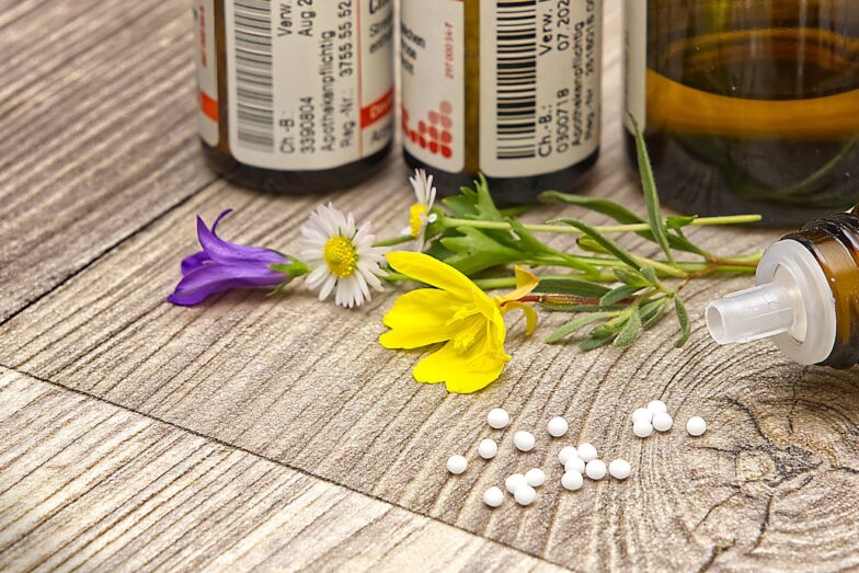 A bottle of medicine sitting on top of a wooden table