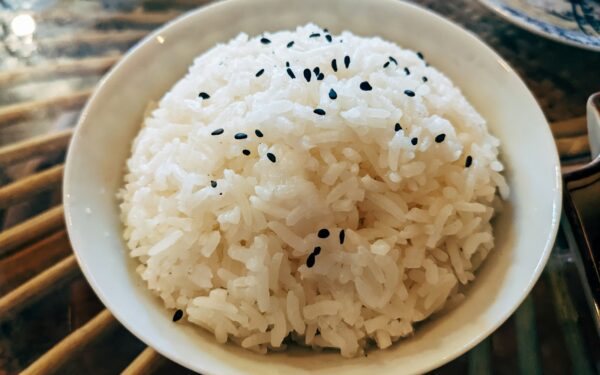a bowl of white rice with black sesame seeds